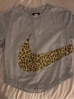 Nike Woman’s Gray Baby Tee with Leopard Swoosh Graphic
